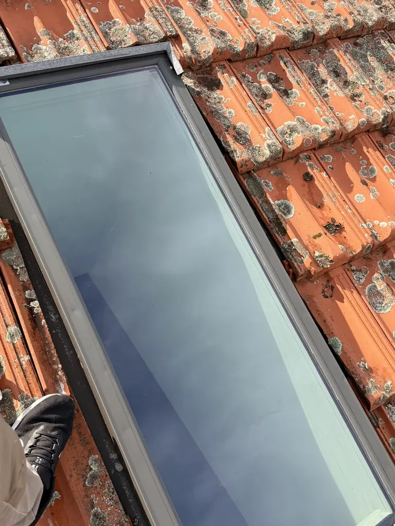 The same roof window after cleaning, glass completely clear